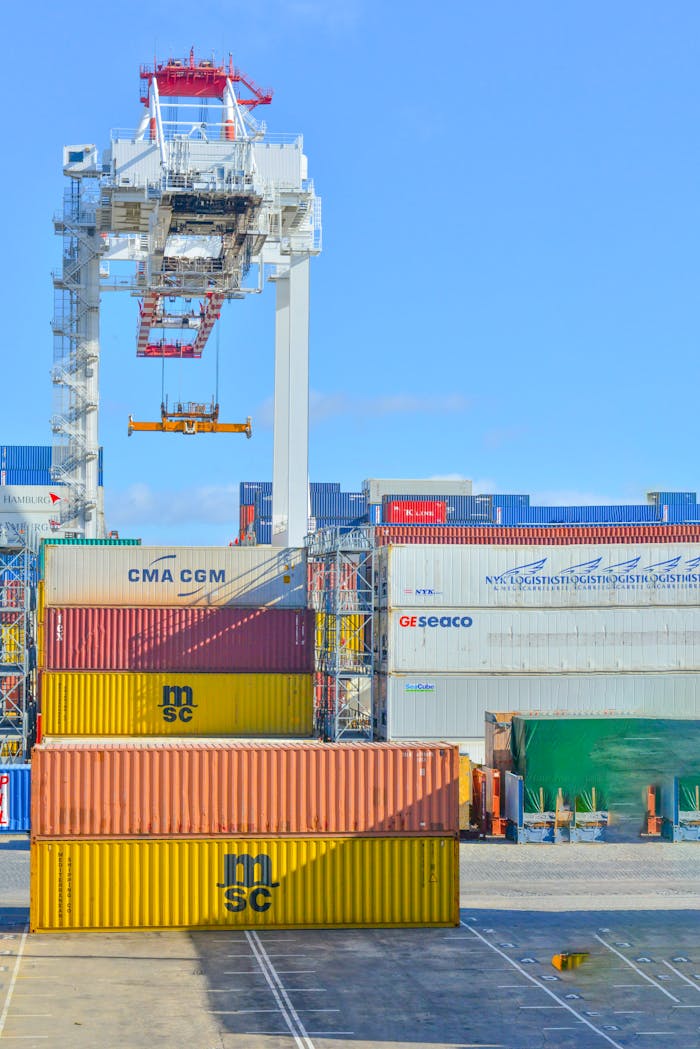 The Art of Drawing Readers In: Your attractive post title goes here Stacked cargo containers in a sunny port industrial setting with crane.